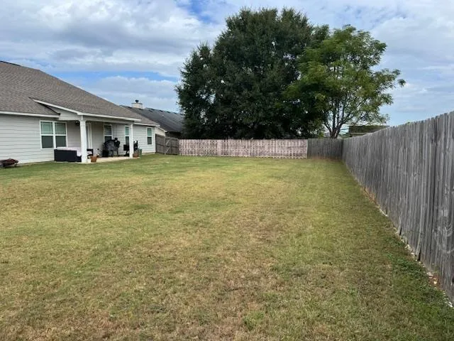 a view of a house with a backyard