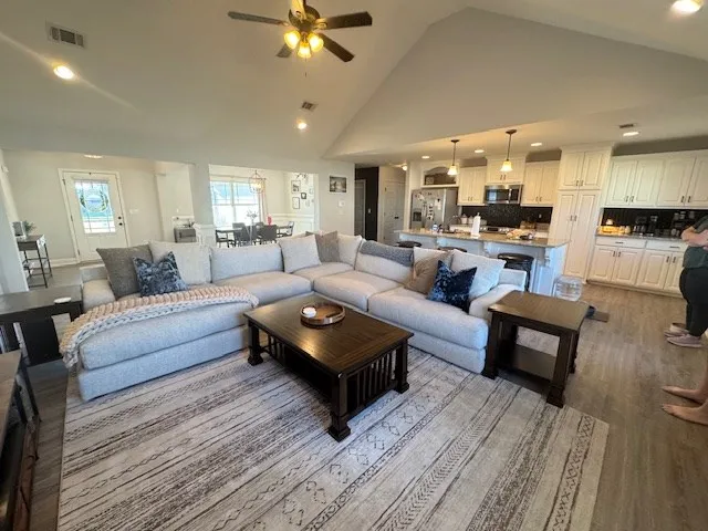 a living room with furniture and a wooden floor