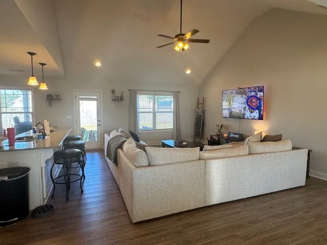 a living room with furniture and a chandelier