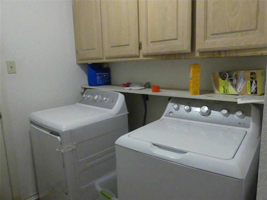 606 West Mulberry Street Decatur, TX 76234 - Photo 17 of 20 Laundry room with washing machine and dryer and cabinet space