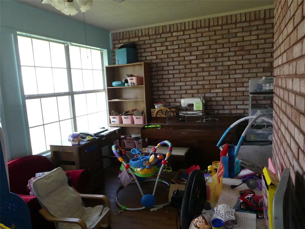 606 West Mulberry Street Decatur, TX 76234 - Photo 18 of 20 Office space featuring wood finished floors and brick wall