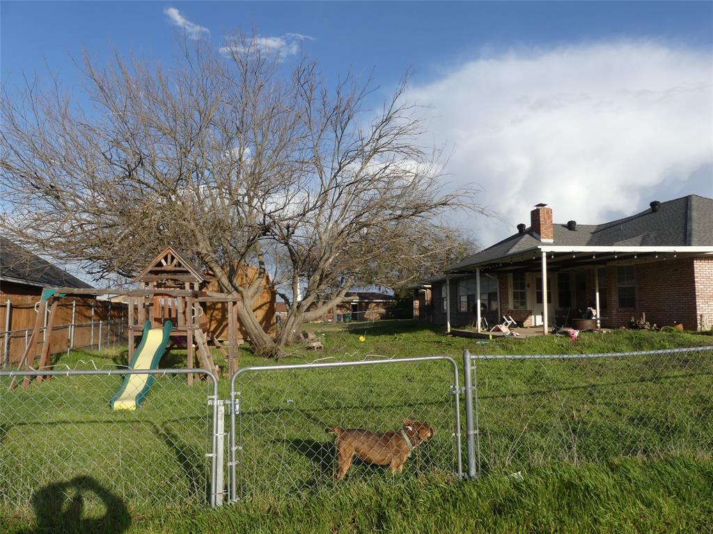 606 West Mulberry Street Decatur, TX 76234 - Photo 6 of 20 View of yard with a playground, a gate, and a fenced backyard