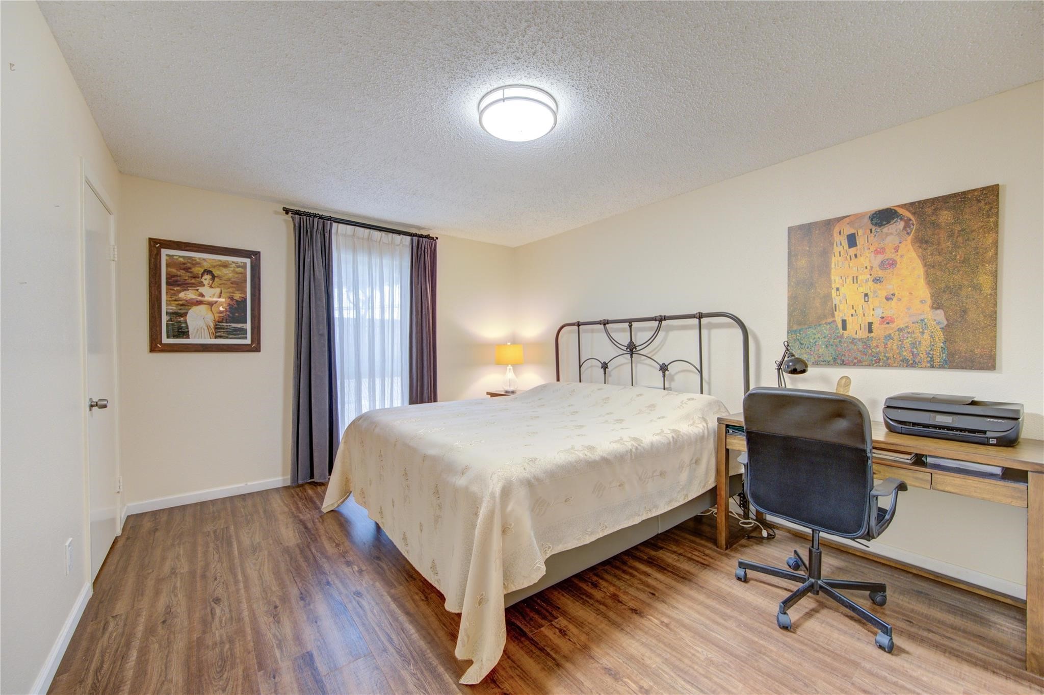 1901 South Voss Road, Unit 4 Houston, TX 77057 - Photo 13 of 26 a bedroom with a bed and a desk