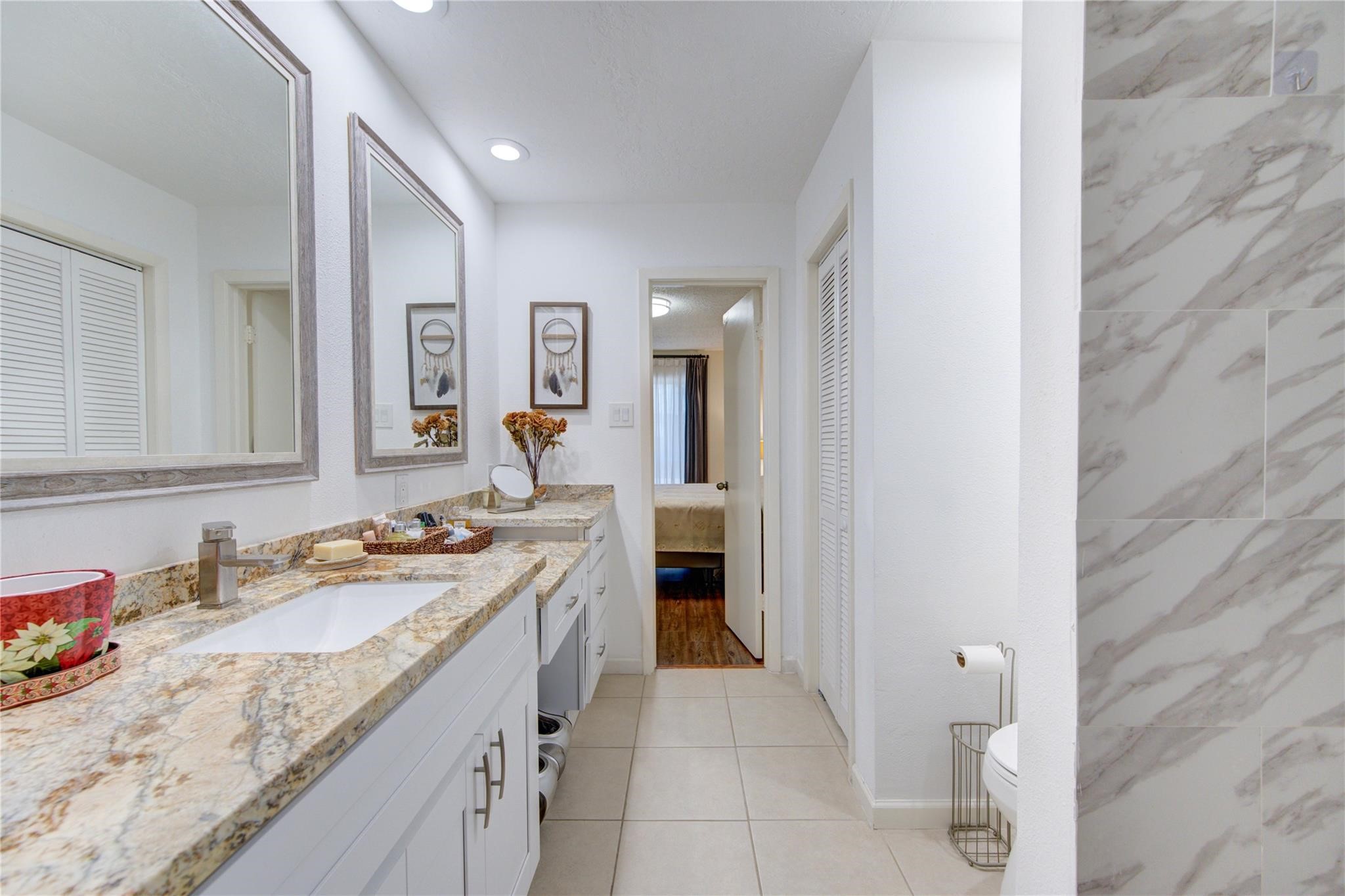 1901 South Voss Road, Unit 4 Houston, TX 77057 - Photo 16 of 26 a spacious bathroom with a granite countertop sink a mirror and a