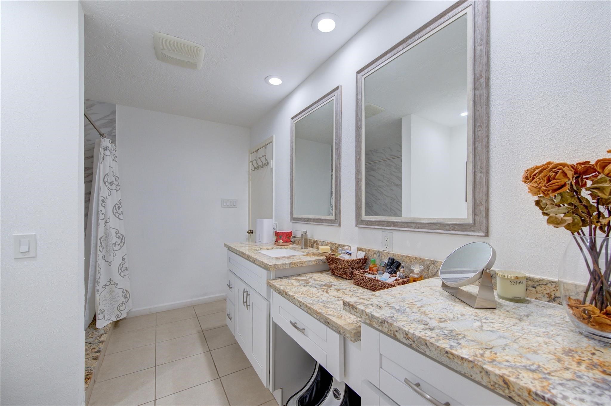 1901 South Voss Road, Unit 4 Houston, TX 77057 - Photo 19 of 26 a bathroom with a granite countertop sink and a mirror