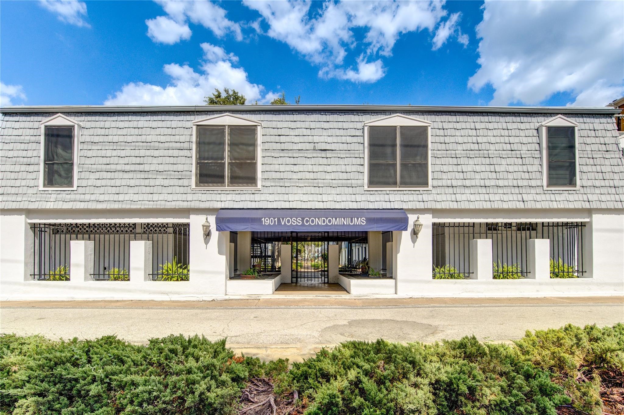 1901 South Voss Road, Unit 4 Houston, TX 77057 - Photo 21 of 26 a front view of a house with a yard