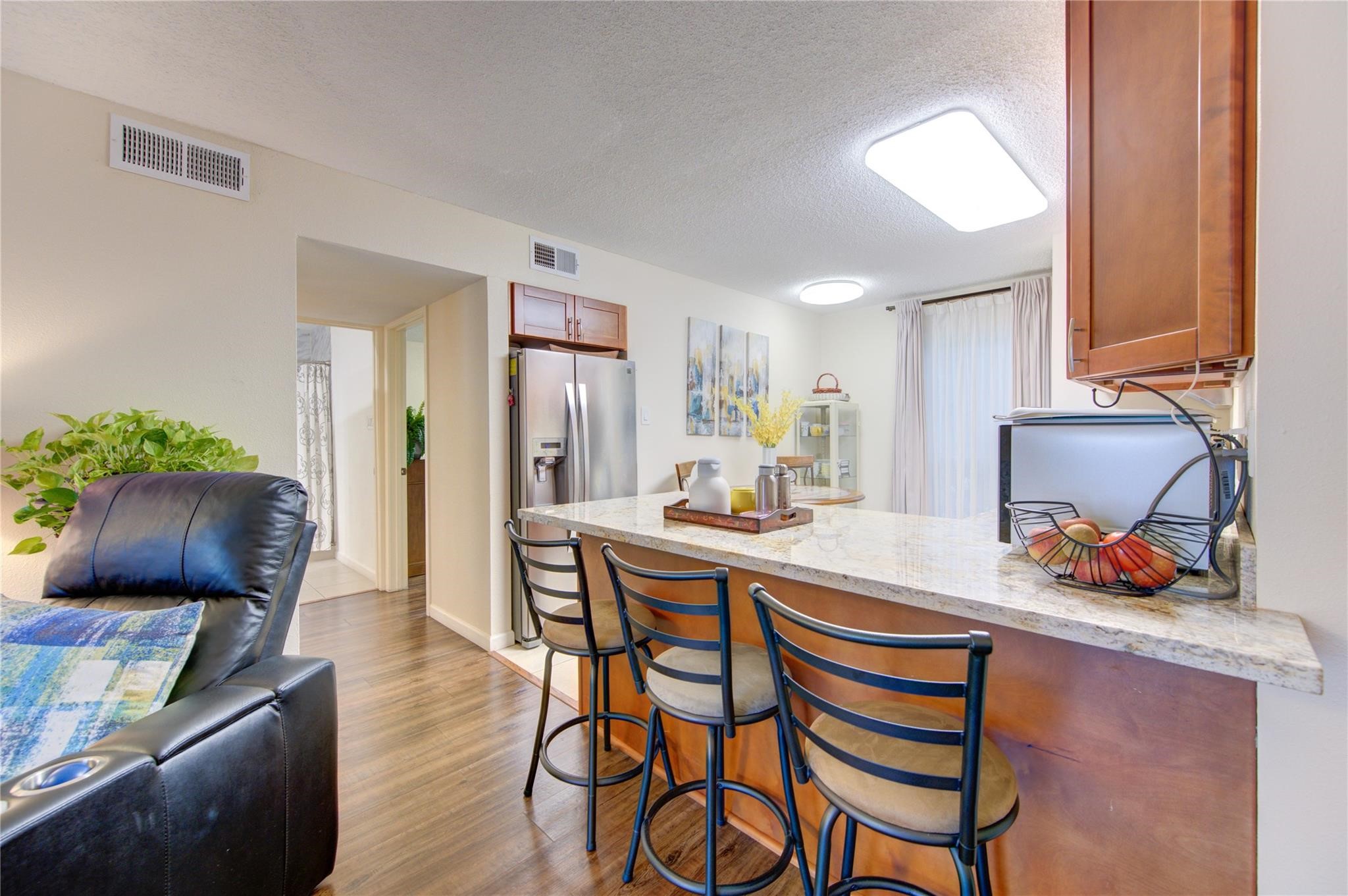 1901 South Voss Road, Unit 4 Houston, TX 77057 - Photo 9 of 26 a kitchen with stainless steel appliances a sink and a refrigerator