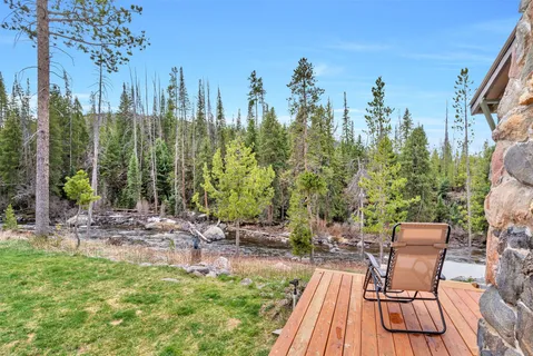 a view of a chairs and table on the wooden deck