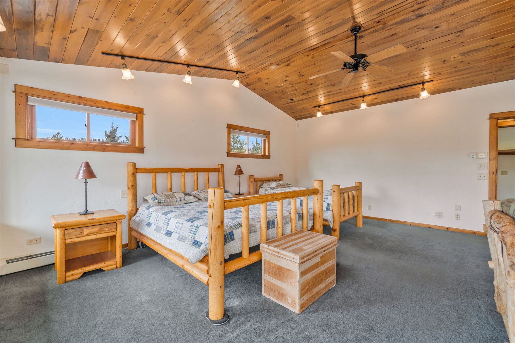 31405 Seedhouse Road Clark, CO 80428 - Photo 26 of 50 a bedroom with bed and a chandelier