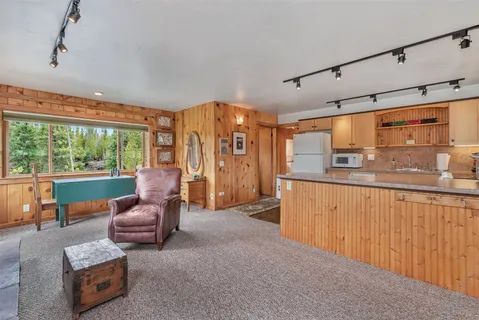 a room with pool table and windows