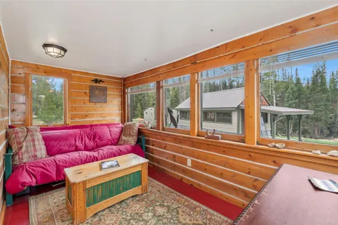 a view of a house with backyard porch and sitting area