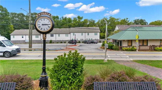 a view of a house with a yard and sitting area