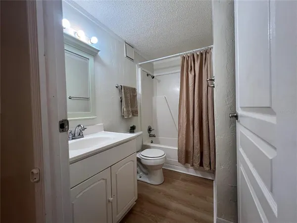 a bathroom with a sink and mirror with toilet