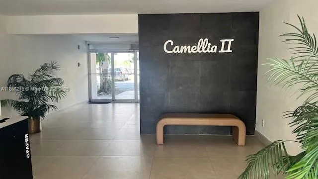 a hallway with a bench and a potted plant