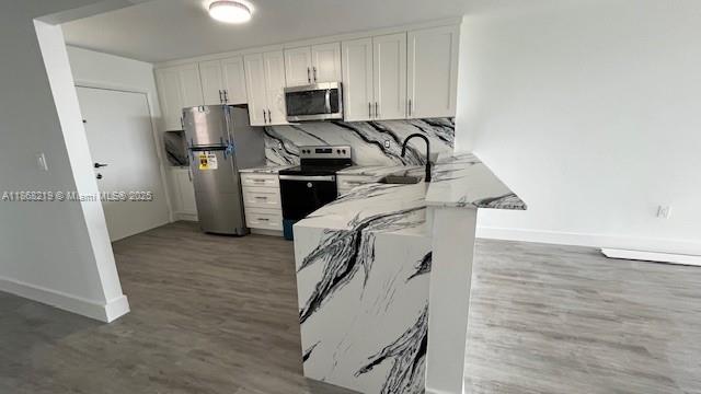 1780 Northeast 191st Street, Unit 8112 Miami, FL 33179 - Photo 2 of 24 a kitchen with stainless steel appliances a refrigerator and a stove top oven