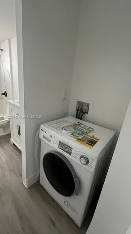 a view of washer and dryer with kitchen in the background