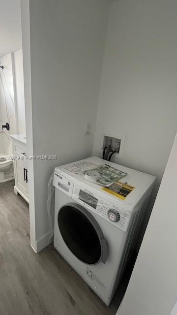 1780 Northeast 191st Street, Unit 8112 Miami, FL 33179 - Photo 21 of 24 a view of washer and dryer with kitchen in the background