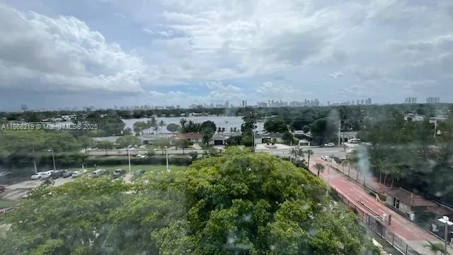 a view of a lake with houses in back