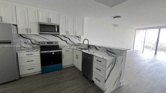 1780 Northeast 191st Street, Unit 8112 Miami, FL 33179 - Photo 3 of 24 a kitchen with granite countertop a sink appliances and cabinets