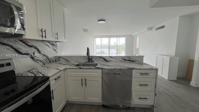 1780 Northeast 191st Street, Unit 8112 Miami, FL 33179 - Photo 4 of 24 a kitchen with stainless steel appliances granite countertop a sink stove and cabinets