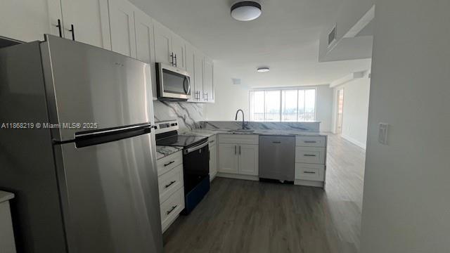 1780 Northeast 191st Street, Unit 8112 Miami, FL 33179 - Photo 5 of 24 a kitchen with stainless steel appliances granite countertop a refrigerator sink and stove