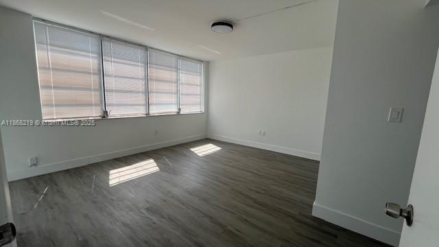 1780 Northeast 191st Street, Unit 8112 Miami, FL 33179 - Photo 7 of 24 an empty room with wooden floor and windows