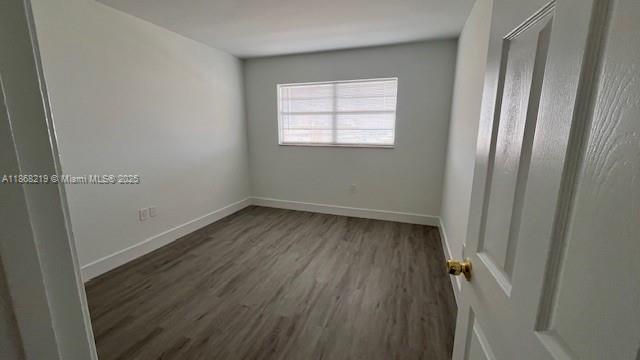 1780 Northeast 191st Street, Unit 8112 Miami, FL 33179 - Photo 8 of 24 wooden floor in an empty room with a window