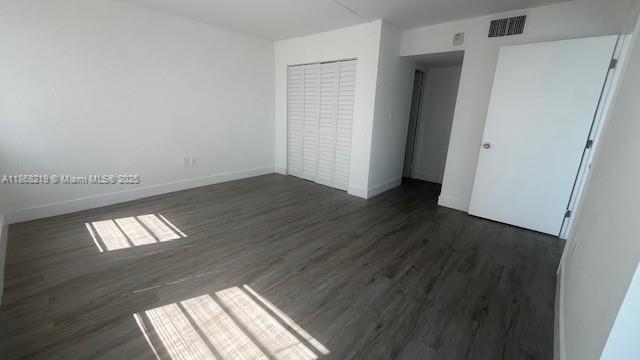 1780 Northeast 191st Street, Unit 8112 Miami, FL 33179 - Photo 9 of 24 a view of empty room with wooden floor and fan