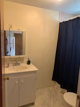 27 Fulton Street Fall River, MA 02720 - Photo 13 of 41 a bathroom with a sink and a mirror