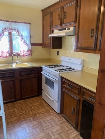 27 Fulton Street Fall River, MA 02720 - Photo 23 of 41 a kitchen with stainless steel appliances granite countertop a stove a sink and a microwave