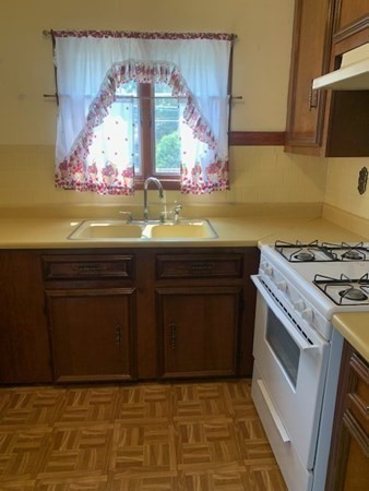 27 Fulton Street Fall River, MA 02720 - Photo 25 of 41 a kitchen with a stove and cabinets