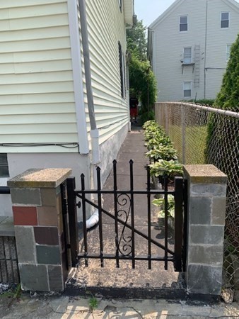 27 Fulton Street Fall River, MA 02720 - Photo 26 of 41 a couple of table and chairs in front of a house