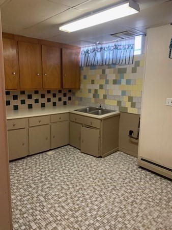 27 Fulton Street Fall River, MA 02720 - Photo 31 of 41 a bathroom with a sink a toilet and mirror