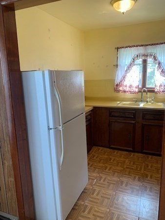 27 Fulton Street Fall River, MA 02720 - Photo 36 of 41 a kitchen with stainless steel appliances a refrigerator and a sink