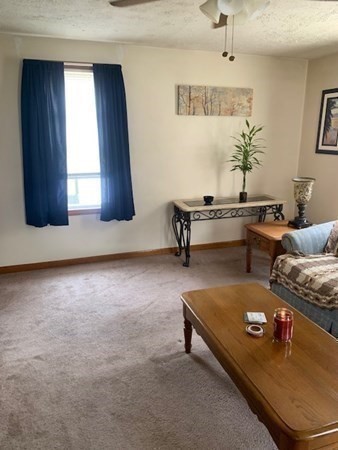 27 Fulton Street Fall River, MA 02720 - Photo 7 of 41 a living room with furniture and a table