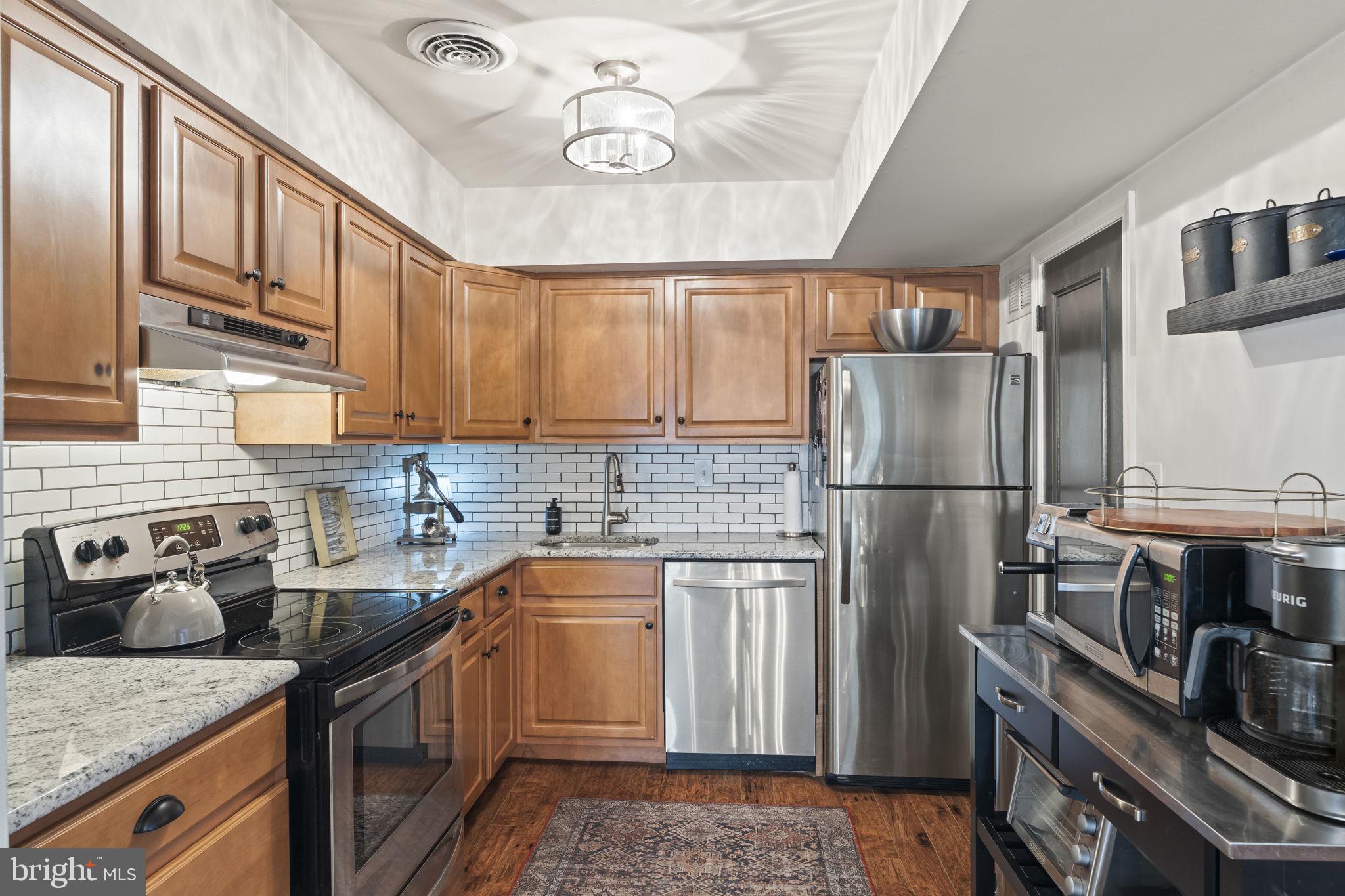 3508 San Rafael Court Springfield, PA 19064 - Photo 8 of 22 a kitchen with stainless steel appliances granite countertop a sink stove and refrigerator