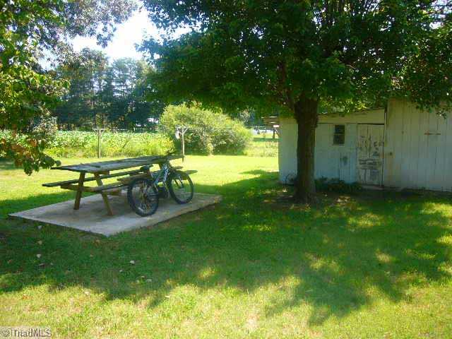 3041 Clyde Road Boonville, NC 27011 - Photo 14 of 14 Bonus. Outdoor picnic area located a few yards from the outbuilding, nestled under a tree for great shade. Also, please notice the outdoor closeline.
