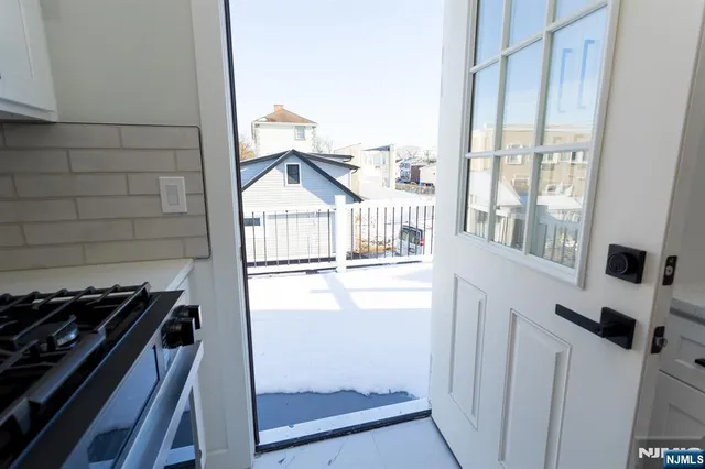 a kitchen with a stove and a window