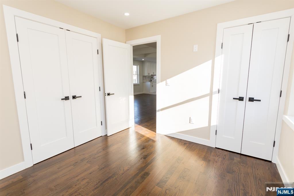 17 Warren Street, Unit 2 Bergenfield, NJ 07621 - Photo 18 of 28 an empty room with wooden floor and a shower