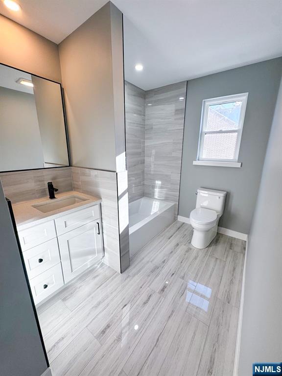 17 Warren Street, Unit 2 Bergenfield, NJ 07621 - Photo 19 of 28 a bathroom with a sink a toilet and shower