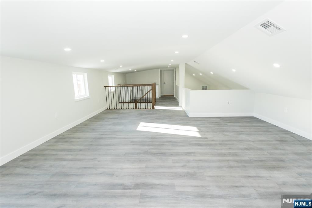 17 Warren Street, Unit 2 Bergenfield, NJ 07621 - Photo 23 of 28 a view of an empty room with wooden floor and a window