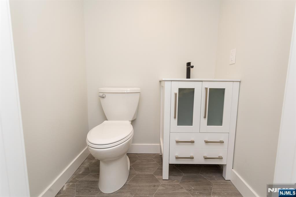 17 Warren Street, Unit 2 Bergenfield, NJ 07621 - Photo 25 of 28 a bathroom with a toilet and a sink