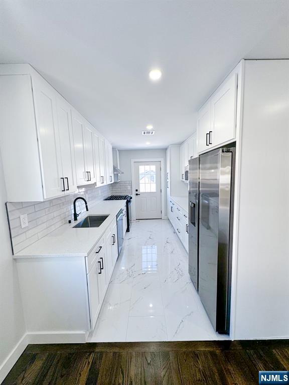 17 Warren Street, Unit 2 Bergenfield, NJ 07621 - Photo 8 of 28 a kitchen with stainless steel appliances granite countertop a sink a refrigerator and a stove