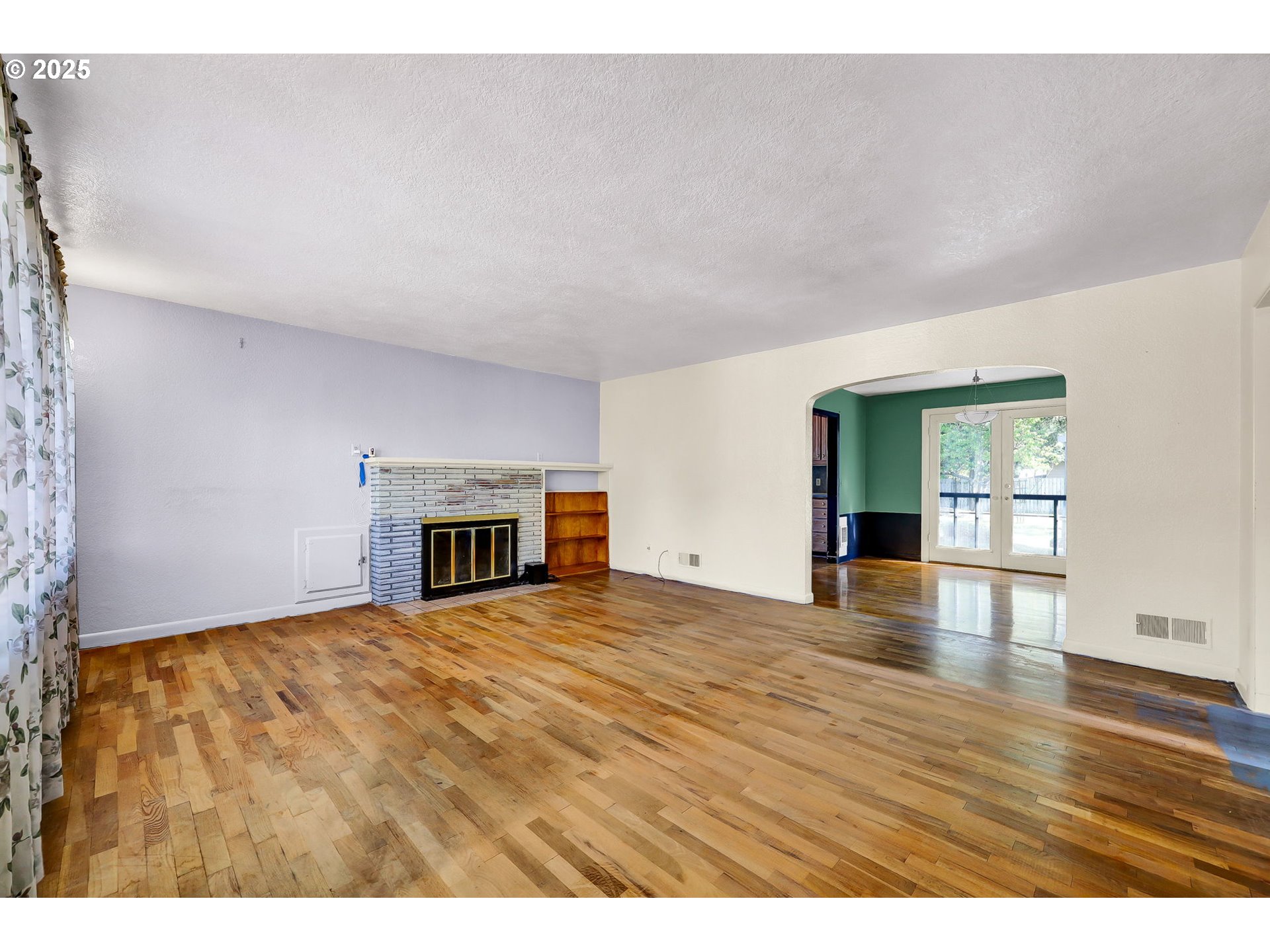 4150 Barger Drive Eugene, OR 97402 - Photo 6 of 28 a view of empty room with wooden floor and fireplace