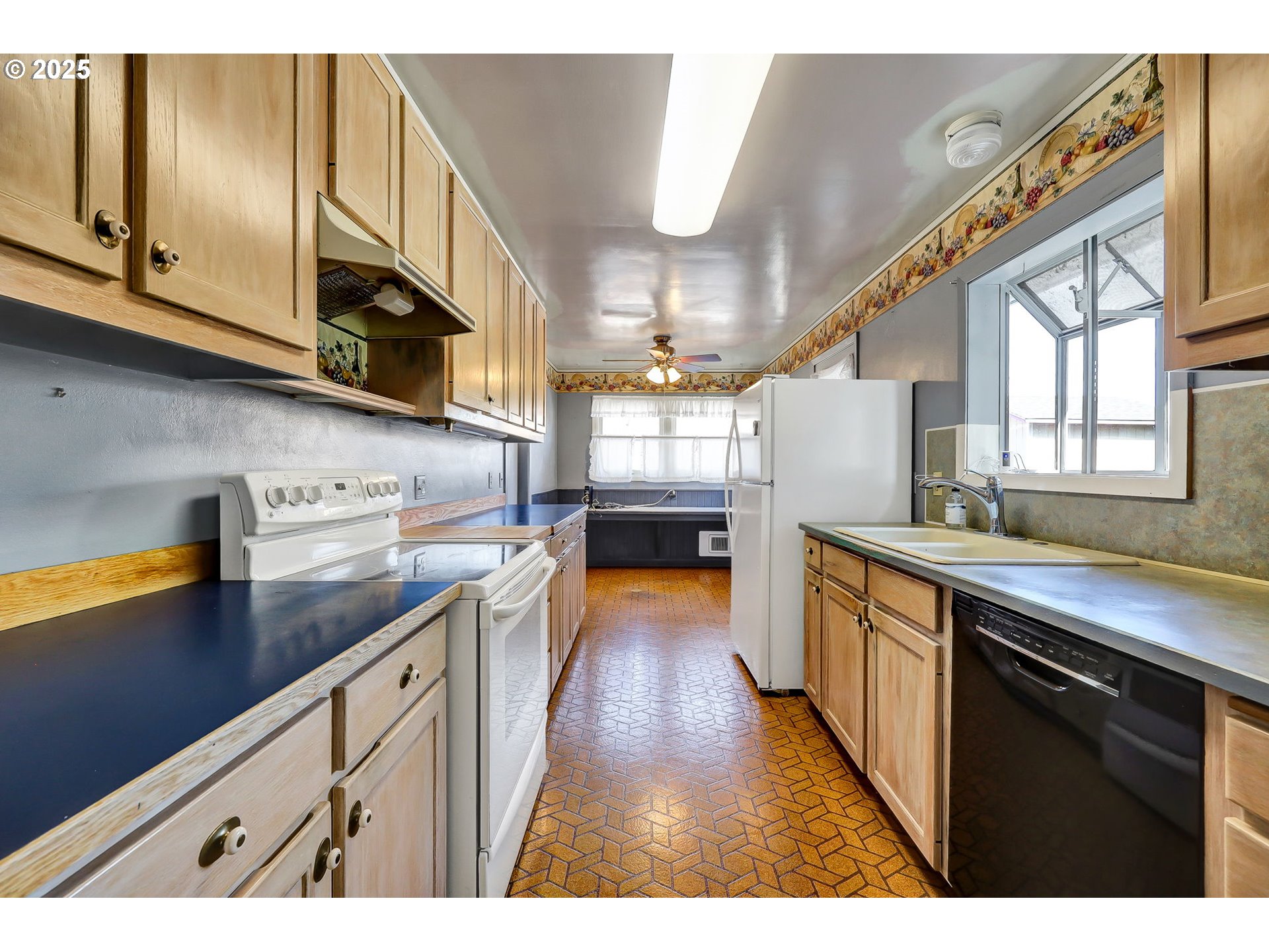 4150 Barger Drive Eugene, OR 97402 - Photo 10 of 28 a kitchen with stainless steel appliances granite countertop a sink a stove and a wooden floors