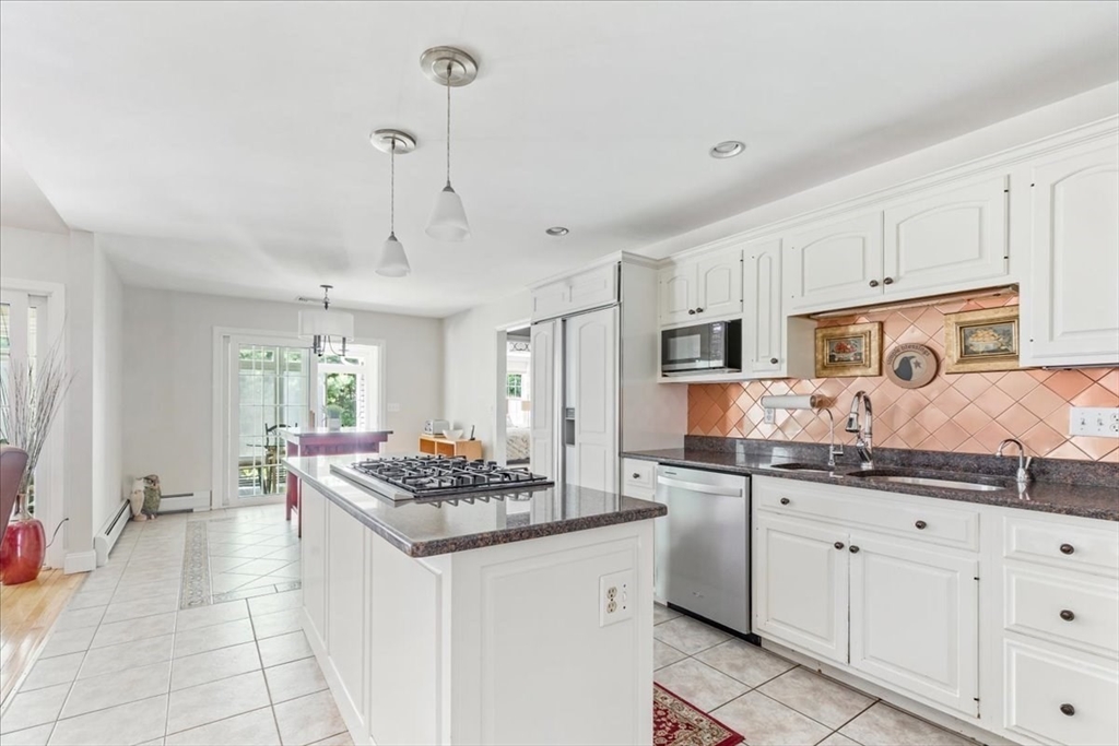 39 Waterfall Road Acushnet, MA 02743 - Photo 11 of 32 a kitchen with stainless steel appliances kitchen island granite countertop a sink and cabinets