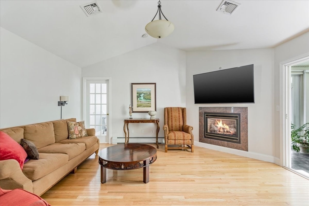 39 Waterfall Road Acushnet, MA 02743 - Photo 5 of 32 a living room with furniture a fireplace and a flat screen tv