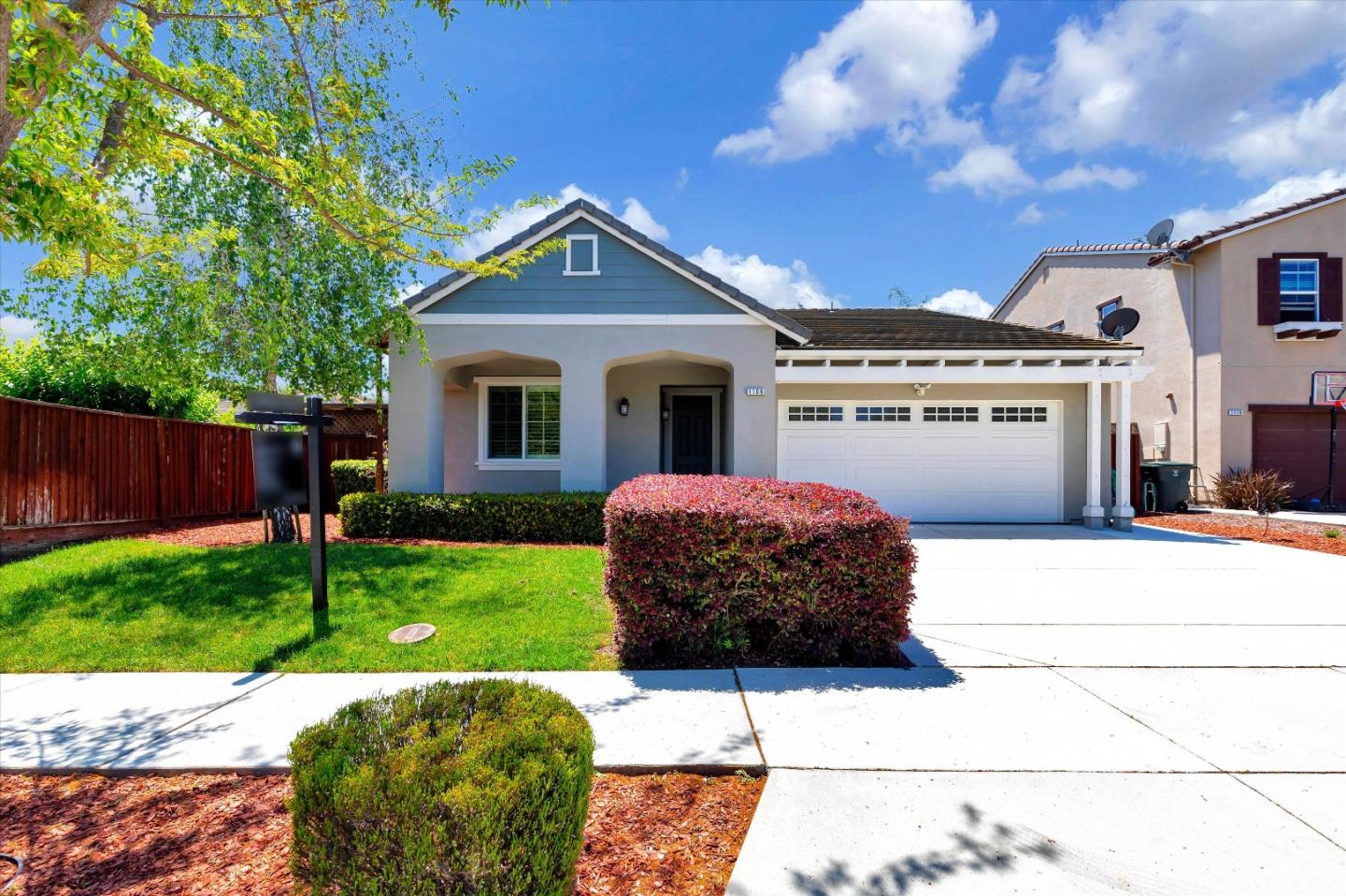 1106 Sprig Way Gilroy, CA 95020 - Photo 1 of 27 a front view of a house with a garden