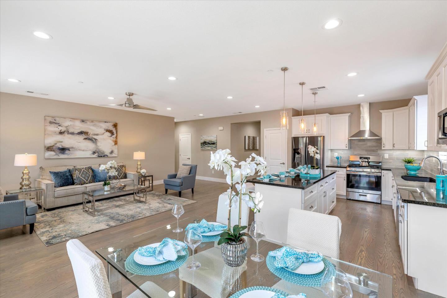 1106 Sprig Way Gilroy, CA 95020 - Photo 11 of 27 a living room with kitchen island furniture and a view of kitchen