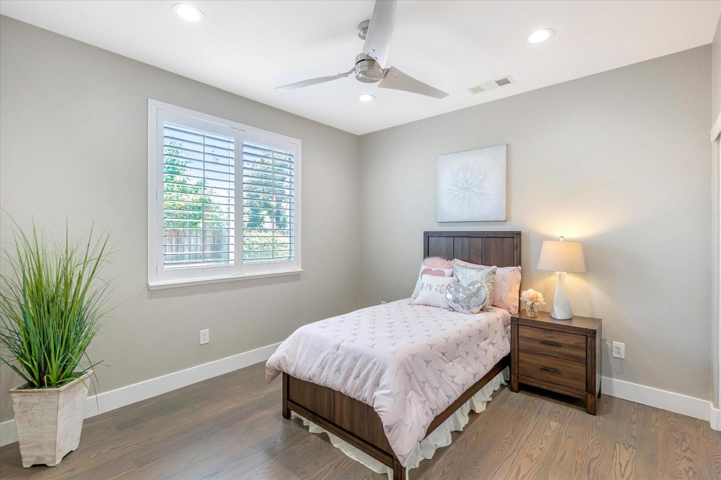 1106 Sprig Way Gilroy, CA 95020 - Photo 13 of 27 a bedroom with a bed and a potted plant